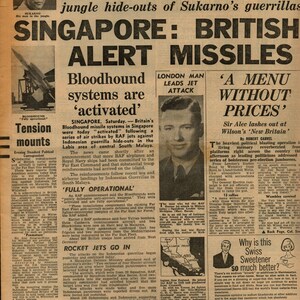 May include: A vintage newspaper from September 12, 1964, with the headline "Singapore: British Alert Missiles." The front page features articles on international affairs, including the RAF and Indonesian conflicts, and advertisements.