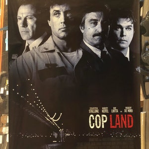 May include: A film poster for the movie "Cop Land" starring Sylvester Stallone, Harvey Keitel, Ray Liotta, and Robert De Niro. The poster is black and white with a bridge in the background. The text "No one is above the law." is at the top of the poster.