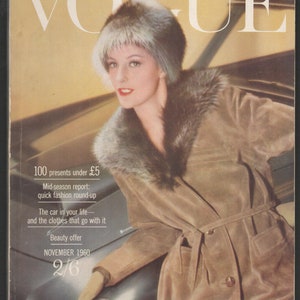 May include: Vogue magazine cover from November 1960. A woman in a fur hat and coat leans against a car. The cover includes text: "100 presents under £5", "Mid-season report: quick fashion round-up", and "Beauty offer".