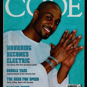 May include: A magazine cover featuring a man wearing a white shirt against a turquoise background. The magazine is titled "CODE" and the cover story is "Mourning Becomes Electric".