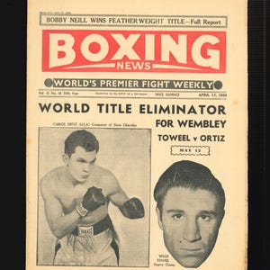 May include: A black and white photo of two boxers, Carlos Ortiz and Willie Towell, on the cover of the Boxing News magazine. The headline reads "World Title Eliminator for Wembley Towell v Ortiz May 12".
