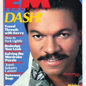 May include: A magazine cover featuring a man with a moustache and a patterned shirt. The magazine is titled "EBONY MAN DASH!" and features the text "Hidden Treasures of Domestic Travel".