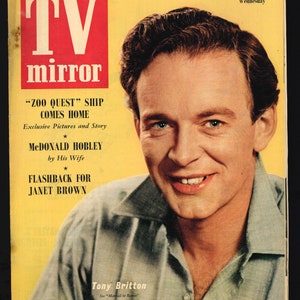 May include: A black and white magazine cover featuring a smiling man with dark hair. The magazine is titled "TV mirror" and features the text "'Zoo Quest' Ship Comes Home" and "McDonald Hobley by His Wife".