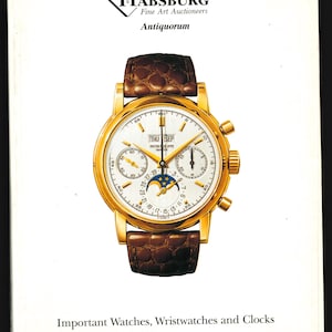May include: A gold wristwatch with a white face and a brown leather strap. The watch features a date window, a moon phase indicator, and a chronograph. The watch is labelled "Patek Philippe Geneve". The image is from an auction catalogue for important watches, wristwatches, and clocks. The auction is taking place on Sunday, 14 October 1990, at the Hotel des Bergues in Geneva.