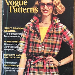 May include: A magazine cover for Vogue Patterns, featuring a woman wearing a red, yellow, and black plaid shirt with a yellow top underneath. The magazine cover text reads "Vogue Patterns" and "Split Season Sewing... Trans-seasoning, New-seasoning!"  The magazine cover also includes the text "Plus! Plus! Plus! 20 inspired pages on wardrobe building our interplay PLUS way!! Move into Madras, Put Color on Color! Red letter day! Christian Aujard's designs arrive at Vogue... postmarked, Paris!"