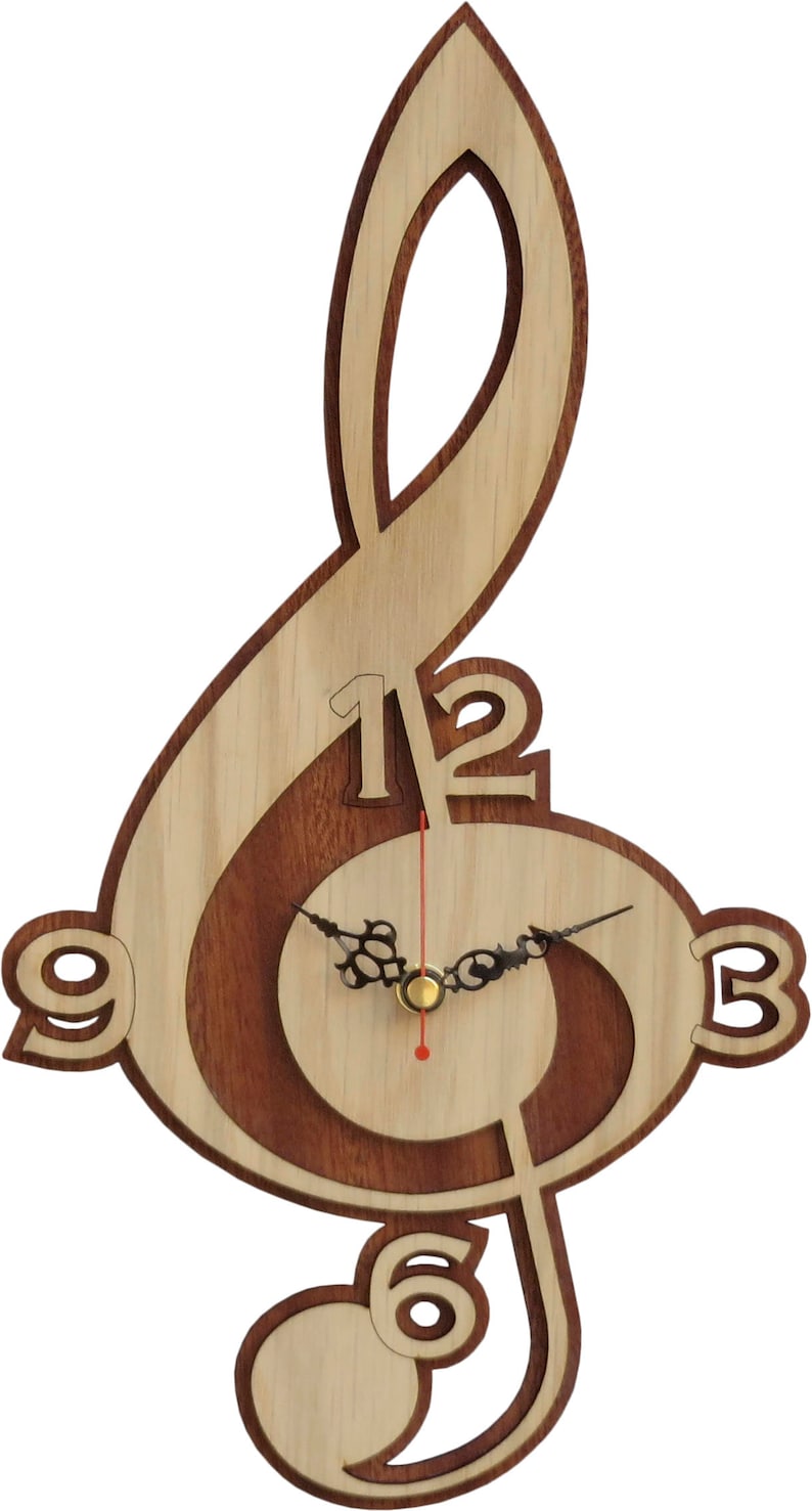 May include: A wooden wall clock shaped like a treble clef. The clock face is surrounded by a brown wood inlay. The numbers 12, 3, 6, and 9 are visible on the clock face.