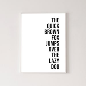 May include: Black and white typography print with the text "The quick brown fox jumps over the lazy dog".
