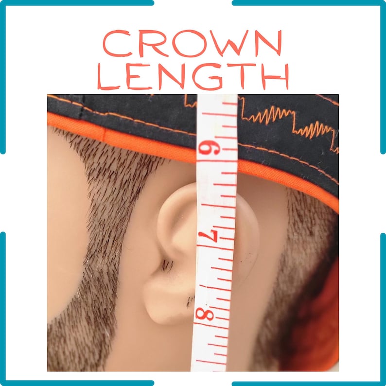 May include: A black cap with orange trim and a jagged orange line pattern, shown on a mannequin head next to a white measuring tape that indicates a crown length measurement between 6 and 8 inches, with the text CROWN LENGTH at the top.