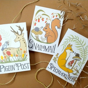 May include: Three illustrated cards with animal and nature themes. The first card features a deer with a bird on its back and the text "Pigeon Post". The second card features a squirrel and a snail with the text "Snail Mail". The third card features a fox and a snail with the text "Special Delivery".