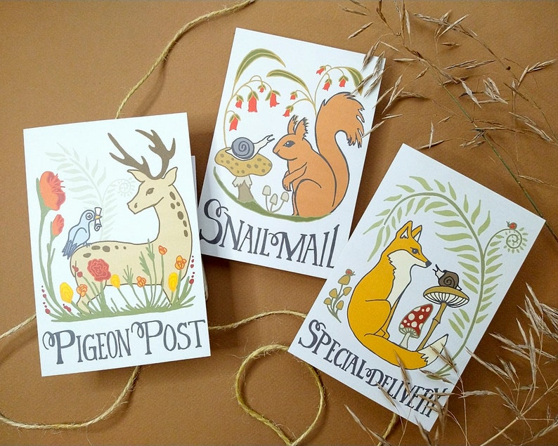 May include: Three illustrated cards with animal and nature themes. The first card features a deer with a bird on its back and the text "Pigeon Post". The second card features a squirrel and a snail with the text "Snail Mail". The third card features a fox and a snail with the text "Special Delivery".