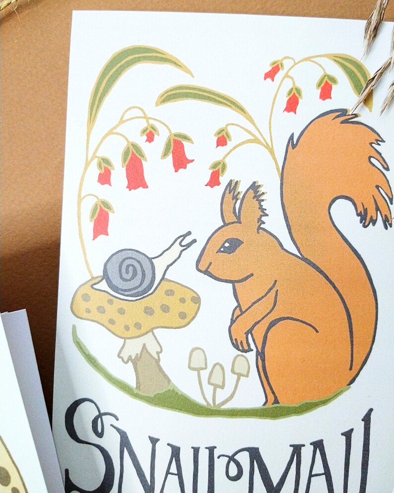 May include: A whimsical illustration of a red squirrel sitting on a green patch of grass with a mushroom and a snail. The background features a green plant with red bell-shaped flowers. The text "Snail Mail" is written in black at the bottom of the image.