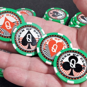 May include: A hand holding a stack of green and white poker chips. Each chip features a different queen of a suit: queen of diamonds, queen of spades, queen of hearts, and queen of clubs.
