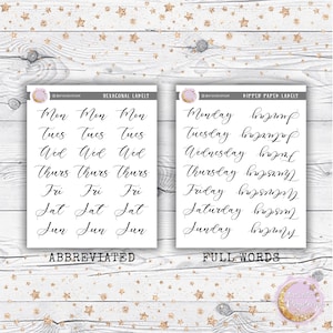 May include: Two sheets of stickers with days of the week written in cursive. The first sheet has the days of the week abbreviated, and the second sheet has the days of the week written out in full. The stickers are on a white background with gold glitter stars.