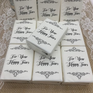 May include: A set of white tissue paper boxes with black text and decorative designs. Each box has the text "For Your Happy Tears" printed on the front.