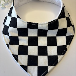 May include: Black and white checkered baby bib with a white terry cloth backing.