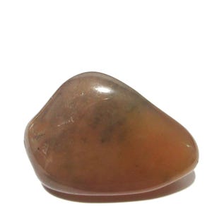 May include: A smooth, polished, tumbled stone with a translucent, warm brownish-orange hue. The surface exhibits subtle variations in colour density and internal cloudiness, creating a soft, rounded, and organic shape with a glossy, reflective finish.