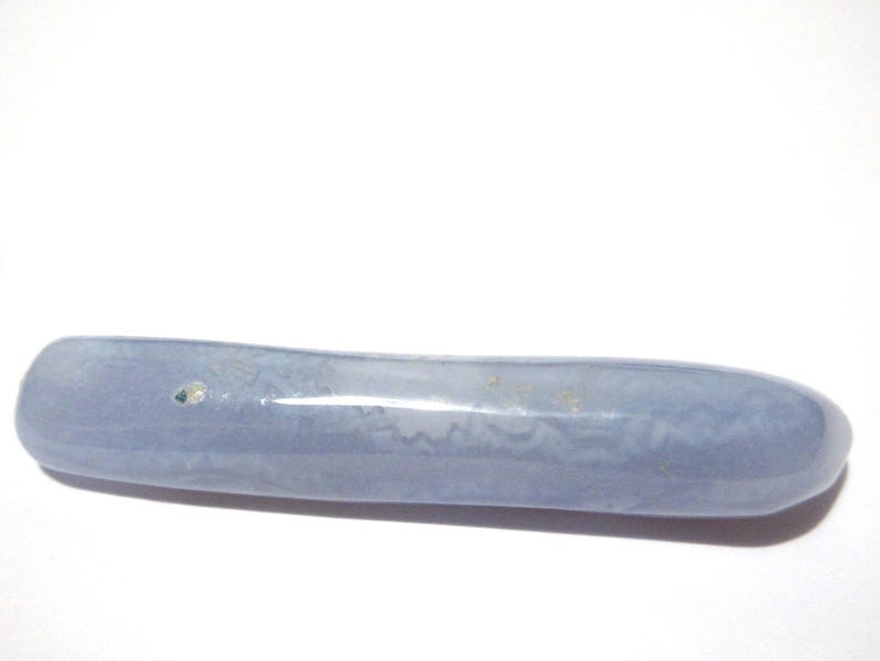 May include: A smooth, elongated, blue-gray stone with a rounded shape. The stone has subtle variations in color and texture, and appears to be polished. The object is set against a plain white background.