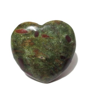 May include: A polished heart-shaped stone featuring a mottled surface with deep forest green, olive, and dark red inclusions. The smooth, rounded object displays a glossy finish that highlights the natural color variations within the mineral.