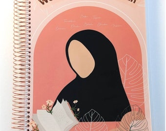May include: A pink and white planner with the text "Well Planned Muslimah Planner" on the cover. The cover features an illustration of a woman wearing a black hijab and reading a book. The illustration is surrounded by pink and white floral designs.