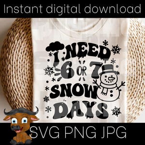 May include: A white t-shirt with the text "I NEED 6 OR 7 SNOW DAYS" in black, with snowflakes and a snowman graphic. The shirt is displayed on a woven basket.