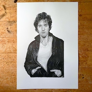May include: Black and white drawing of a man with curly hair wearing a leather jacket. He is looking directly at the viewer with a serious expression.