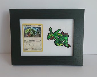 Puede incluir: Una imagen enmarcada de una carta de Pokémon Rayquaza verde y un Rayquaza de pixel art verde. La carta tiene el texto "Rayquaza - 120" y "Turbo Storm" y "Dragon Claw".