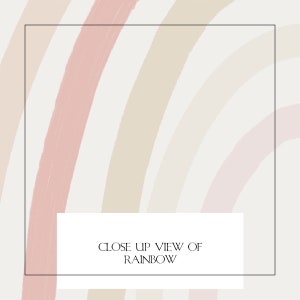 Close-up of a pastel rainbow print with soft tones of beige, pink, and peach, framed for modern nursery or gender-neutral kids room decor.