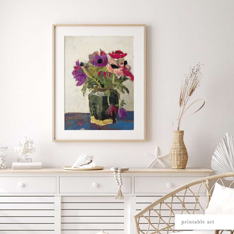 Framed botanical art print styled on a modern console table, adding warmth and color to any home.