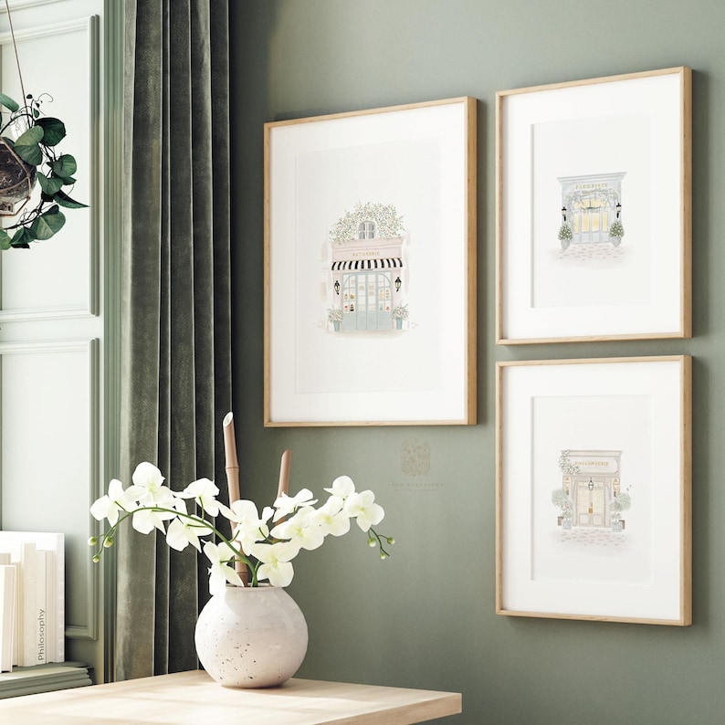 A set of three watercolor art prints featuring a boulangerie, a florist, and a patisserie, perfect for Parisian-inspired home decor.