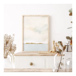 Framed abstract ocean art set with soft watercolor hues and a modern horizon design, perfect for adding a peaceful, beachy touch to your decor.