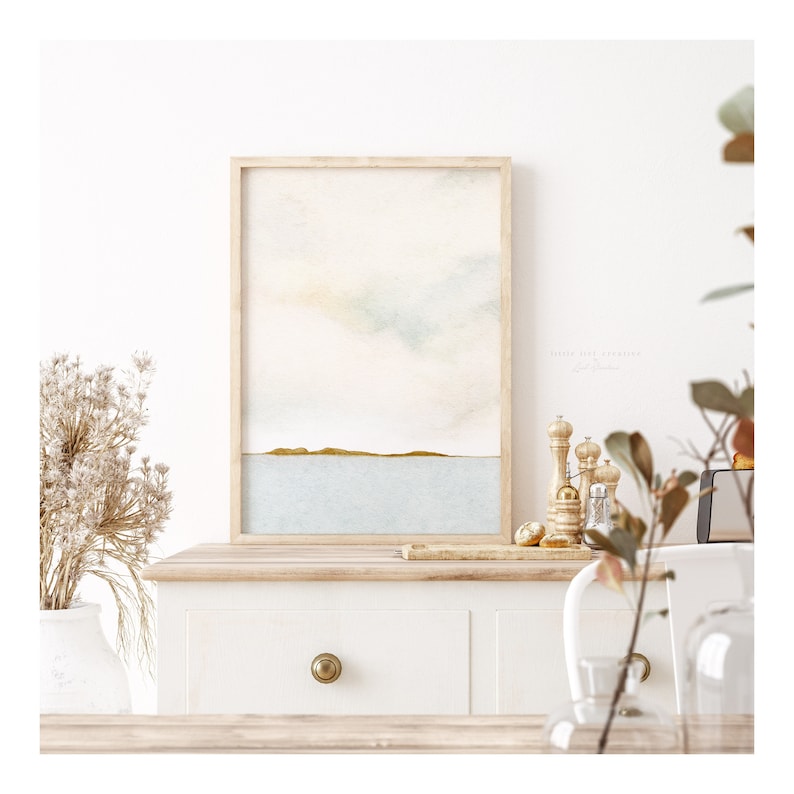 Framed abstract ocean art set with soft watercolor hues and a modern horizon design, perfect for adding a peaceful, beachy touch to your decor.