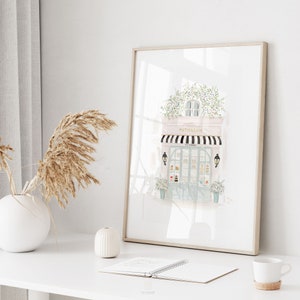 Whimsical French cafe artwork in neutral pinks and beige, displayed in a cozy teen girls' room for a Parisian decor theme.