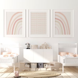 Set of three pastel prints, including rainbow and stripe designs, framed for a serene and modern gender-neutral nursery or twin room.