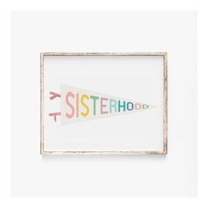 Sisterhood pennant flag print in a neutral frame, modern girl power decor, printable feminist artwork for stylish spaces.