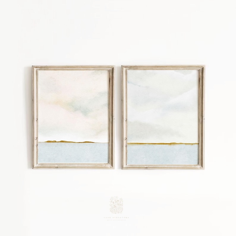 Minimalist beach-inspired wall art duo displayed in a bright, airy space with natural wood tones and soft linen textures.