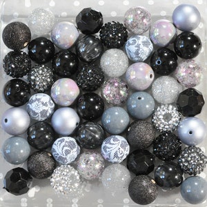 May include: A collection of black, silver and grey beads with various textures and designs, including lace, glitter and rhinestones.