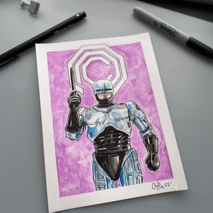 May include: Watercolor painting of RoboCop in a blue and silver suit, holding a gun. The background is a purple wash with a white logo. The artwork is signed "Coffin 22".