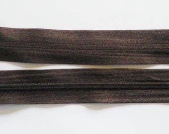 Zipper zips Brown