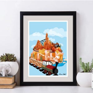 May include: A colourful illustration of a train travelling through a mountain range. The train is red, black and brown with white accents. The mountain range is a mix of orange, brown and yellow. The sky is blue with white clouds.