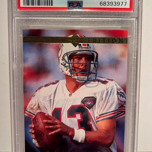 May include: A 1995 Upper Deck SE Dan Marino Gold football card, graded MINT 9 by PSA, encased in a protective holder. The card features a color image of Dan Marino in his football uniform, holding a football.