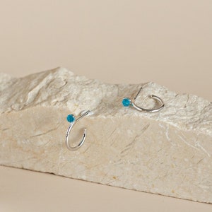 Semi-hoop earrings with light blue spherical zirconia made of sterling silver and gold-plated silver