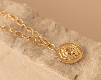 Coin-shaped embossed lion pendant necklace made of sterling silver and 24k gold-plated silver