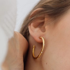 Thick hoops with inlaid zircons separated from each other in silver and 24k gold plated