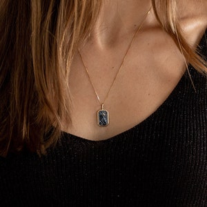 Rectangular pendant necklace with hand engraved black turquoise stone and inlaid moon made of gold plated sterling silver
