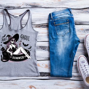 May include: A gray tank top with a graphic print of a witch in a pool with the text "Hot Ghoul Summer".