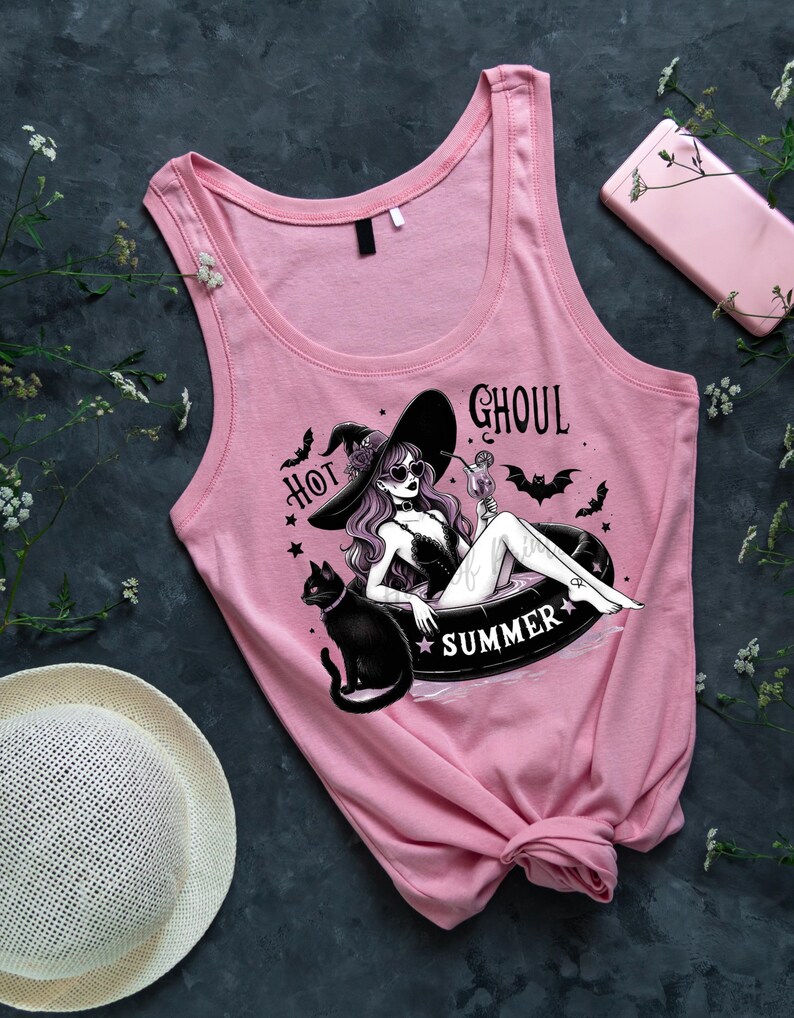 May include: Pink tank top with a graphic of a witch in a witch hat, sunglasses, and a black cat, floating in a pool with the text "Hot Ghoul Summer".