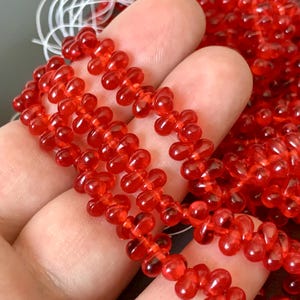 Beautiful transparent siam Czech glass drops! Sold per 50 beads. SKU 11803