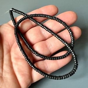 No label, but I believe that these are Blackstone (gemstone) beads. Sold per 16 inch long strand. SKU 04219