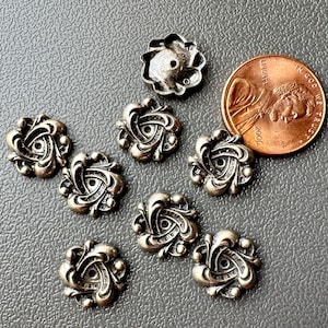 Intricate patterns in these tiny vintage brass stampings! Dark silver plated brass from the Haskell buyout. Sold per 4 pieces. SKU 11306