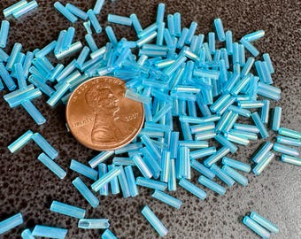 Lovely baby blue AB bugle beads. Sold per 10 gram tubes. SKU 17512